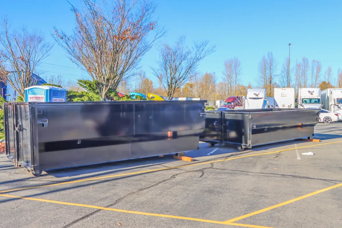 Professional dumpster rental service with roll-off container on residential driveway in East Wenatchee